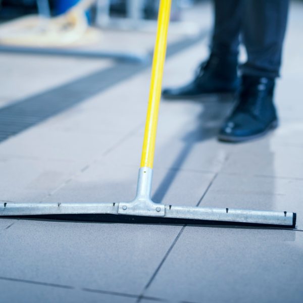 close-up-floor-wiper-mop-cleaning-industrial-plant
